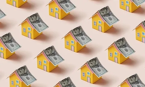 A series of houses with $100 bills instead of roofs