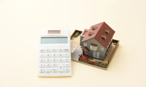 A model house next to a calculator