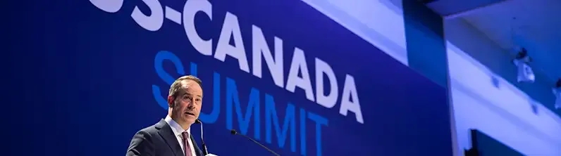 Darryl White speaking at a podium