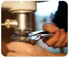 Une personne répare le drain de sa maison