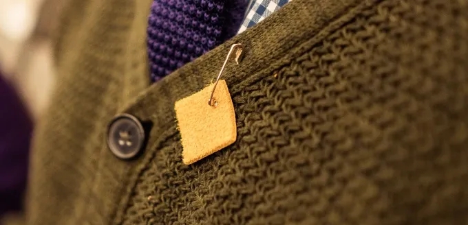 Close up of cardigan with yellow square pin