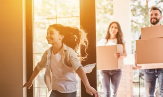 A couple move into their new home as their daughter excitedly enters the front door