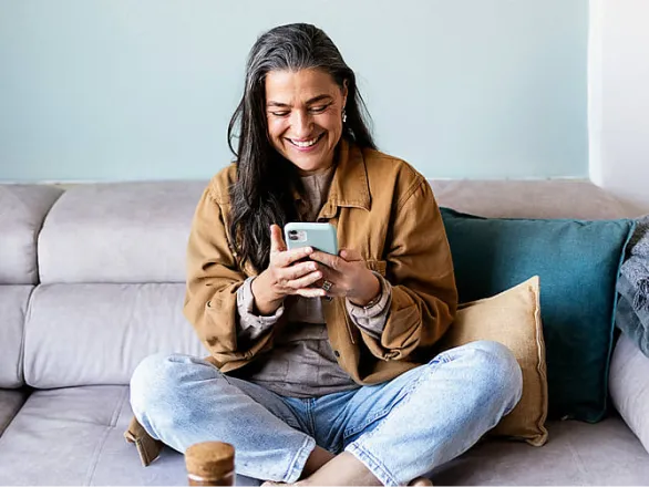 Woman checking her phone and smiling