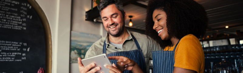 Man and woman hold iPad