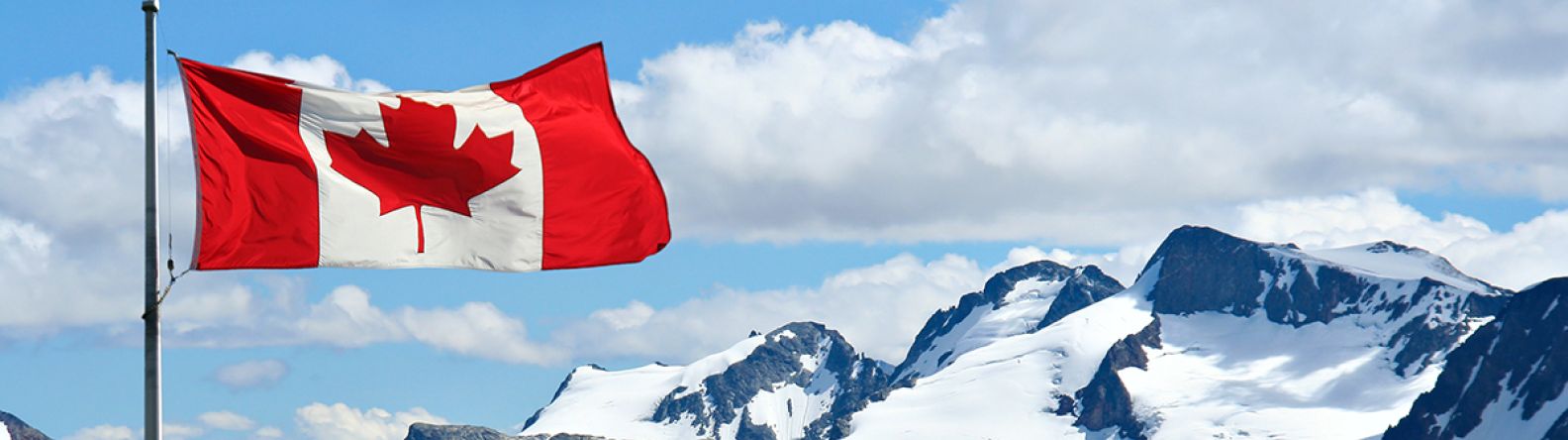 Canadian flag over the Rocky Mountains