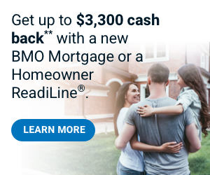 A young couple holding a child looks on happily outside their home