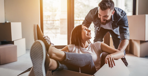 A couple move into a home they bought with the help of a mortgage.