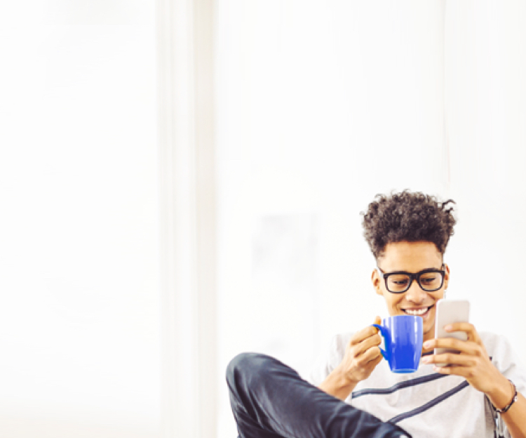 young man with glasses casually sitting, drinking coffee and using BMO chatbot on his mobile phone 