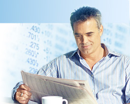 Smiling man reading the paper